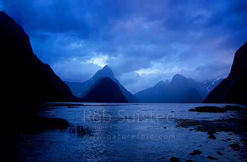 Mitre Peak (1683m) centre-left, at dusk in Milford Sound, Fiordland National Park, Southland District, Southland Region, New Zealand (NZ)