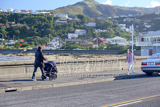 Mother exercising and walking baby with pram at Island Bay, Wellington, Wellington City District, Wellington Region, New Zealand (NZ)