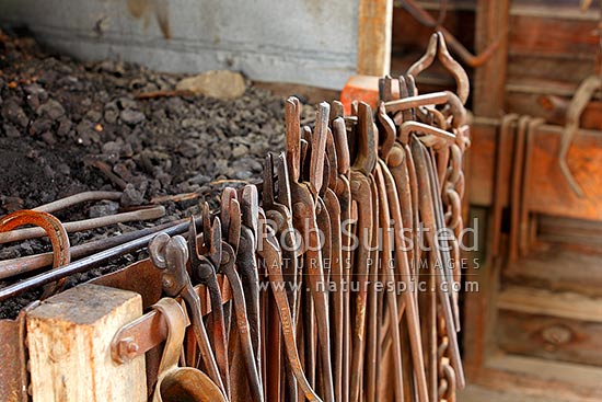 Blacksmith tools hanging on the forge inside the smithy, blacksmiths shop, Molesworth Station, Marlborough District, Marlborough Region, New Zealand (NZ)