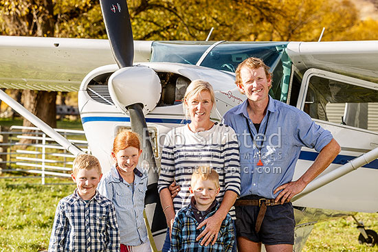 The Murray Family at The Branches - Arthur, Annabel, Dougal, Georgie and James, beside their plane, Branches Station, Shotover Valley, Queenstown Lakes District, Otago Region, New Zealand (NZ)