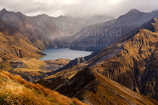 Lochnagar, in the Richardson Mountains and Shotover Conservation Area. Cleft Peak above (2250m) in cloud, Shotover River, Queenstown Lakes District, Otago Region, New Zealand (NZ)