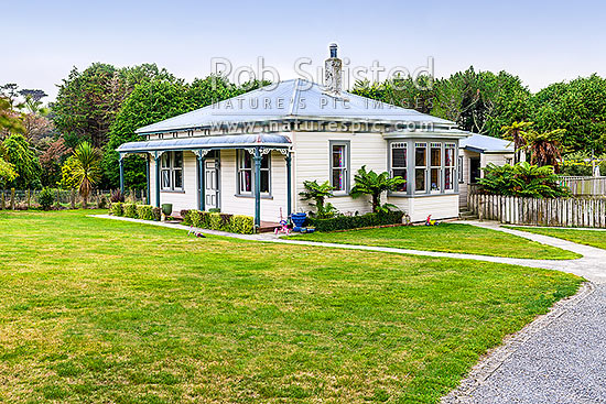 Old neatly kept farmhouse and lawn, with childrens toys about, New Zealand (NZ)