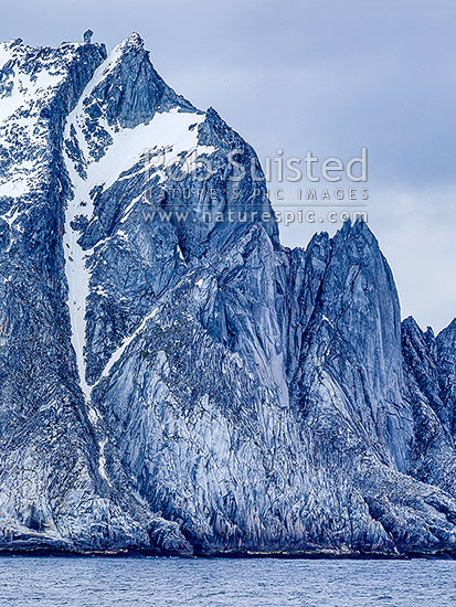 Cornwallis Island, a barren rugged island in the Antarctic South Shetland Islands group. Distinctive rock tor on summit. Square format, Elephant Island, Antarctica Region, Antarctica