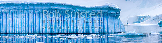 Iceberg in Antarctica showing vertical striations pattern caused by melt air bubble fluting. Polar panorama, Antarctic Peninsula, Antarctica Region, New Zealand (NZ)