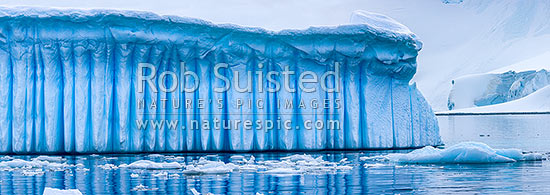 Iceberg in Antarctica showing vertical striations pattern caused by melt air bubble fluting. Polar panorama, Antarctic Peninsula, Antarctica Region, New Zealand (NZ)