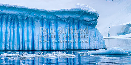 Iceberg in Antarctica showing vertical striations pattern caused by melt air bubble fluting. Polar panorama, Antarctic Peninsula, Antarctica Region, New Zealand (NZ)