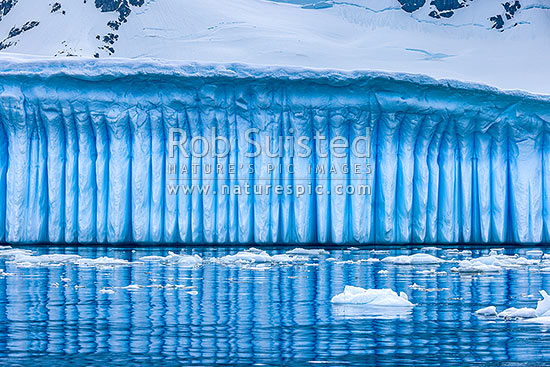 Iceberg in Antarctica showing vertical striations pattern caused by melt air bubble fluting. Polar panorama, Antarctic Peninsula, Antarctica Region, New Zealand (NZ)