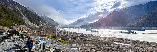 Tourist visitors at lookout above the Tasman Glacier morraine and terminal lake. Aoraki Mount Cook Range left, Burnett Range right. Tasman Valley. Panorama, Mount Cook National Park, MacKenzie District, Canterbury Region, New Zealand (NZ)