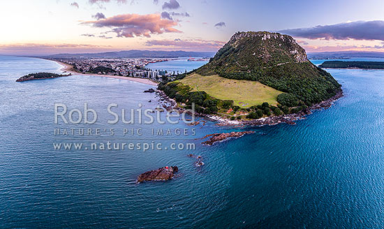 Mount Maunganui, or Mauao, at the Tauranga Harbour Entrance. 231m high lava dome. Moturiki and Motuotau Islands at left. Aerial view at dusk, Mount Maunganui, Tauranga District, Bay of Plenty Region, New Zealand (NZ)