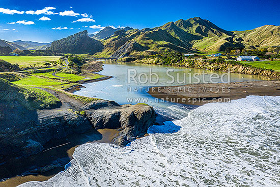 Oterei River mouth at Te Awaiti. Te Awaiti Station and farmland to right. Aerial view, Tora, South Wairarapa District, Wellington Region, New Zealand (NZ)