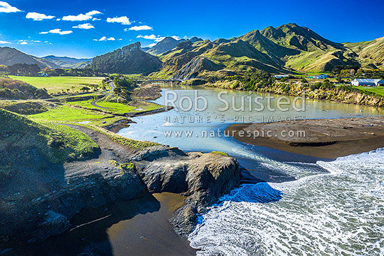 Te Awaiti surf and waves rolling into the Oterei River Mouth at Tora beach. Te Awaiti Station beyond, Tora, South Wairarapa District, Wellington Region, New Zealand (NZ)