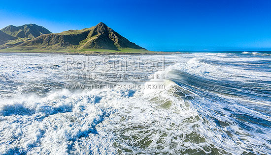 Te Awaiti surf and waves rolling into the Oterei River Mouth at Tora beach. Te Awaiti Station beyond, Tora, South Wairarapa District, Wellington Region, New Zealand (NZ)