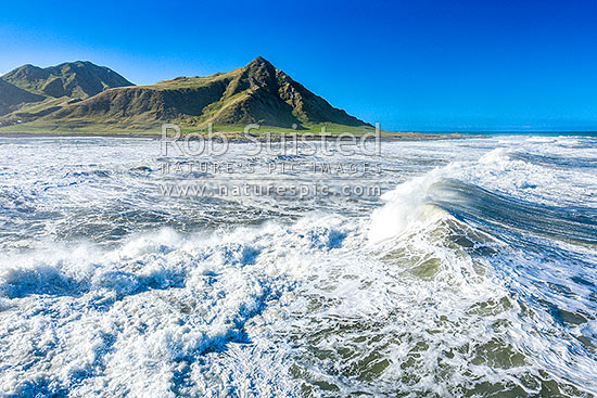 Te Awaiti surf and waves rolling into the Oterei River Mouth at Tora beach. Te Awaiti Station beyond, Tora, South Wairarapa District, Wellington Region, New Zealand (NZ)