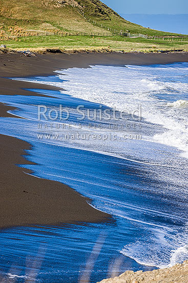 Te Awaiti surf and waves rolling into the Oterei River Mouth at Tora beach. Te Awaiti Station beyond, Tora, South Wairarapa District, Wellington Region, New Zealand (NZ)