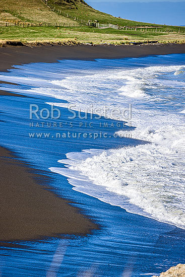 Te Awaiti surf and waves rolling into the Oterei River Mouth at Tora beach. Te Awaiti Station beyond, Tora, South Wairarapa District, Wellington Region, New Zealand (NZ)