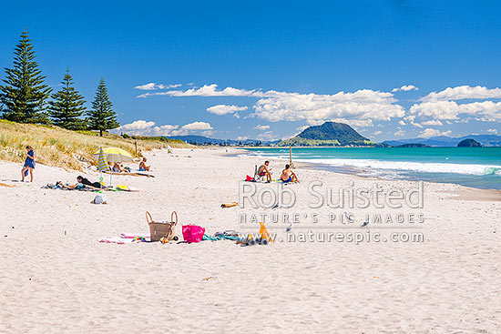 Papamoa Beach on a summer day with people enjoying the summer sunshine. Looking west towards Mt Maunganui Mauao (231m), Papamoa Beach, Tauranga District, Bay of Plenty Region, New Zealand (NZ)