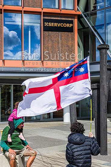 Hikoi mo te Tiriti March protesters against the Treaty Principles Bill in Wellington 19 November 2024, on waterfront. Ironic signage and United Tribes of New Zealand flag, Wellington, Wellington City District, Wellington Region, New Zealand (NZ)