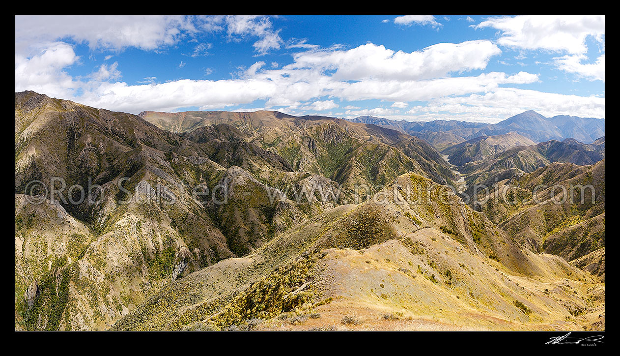 Image of Clarence Reserve, from Blind Saddle down Seymour Stream towards the Clarence River. Inland Kaikouras and St Bernard (2256m right) beyond. Split Rock stream left. Panorama, Clarence Reserve, Kaikoura District, Canterbury Region, New Zealand (NZ) stock photo image