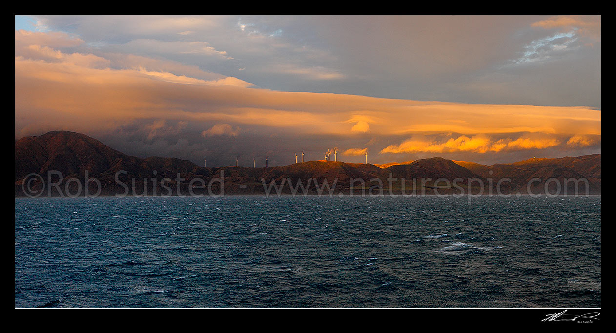 Image of Breaking weather over the Meridian Energys Project West Wind farm turbines on Wellington's South Coast, seen from Cook Strait. Terawhiti coast and station. Panorama, Cape Terawhiti, Wellington City District, Wellington Region, New Zealand (NZ) stock photo image