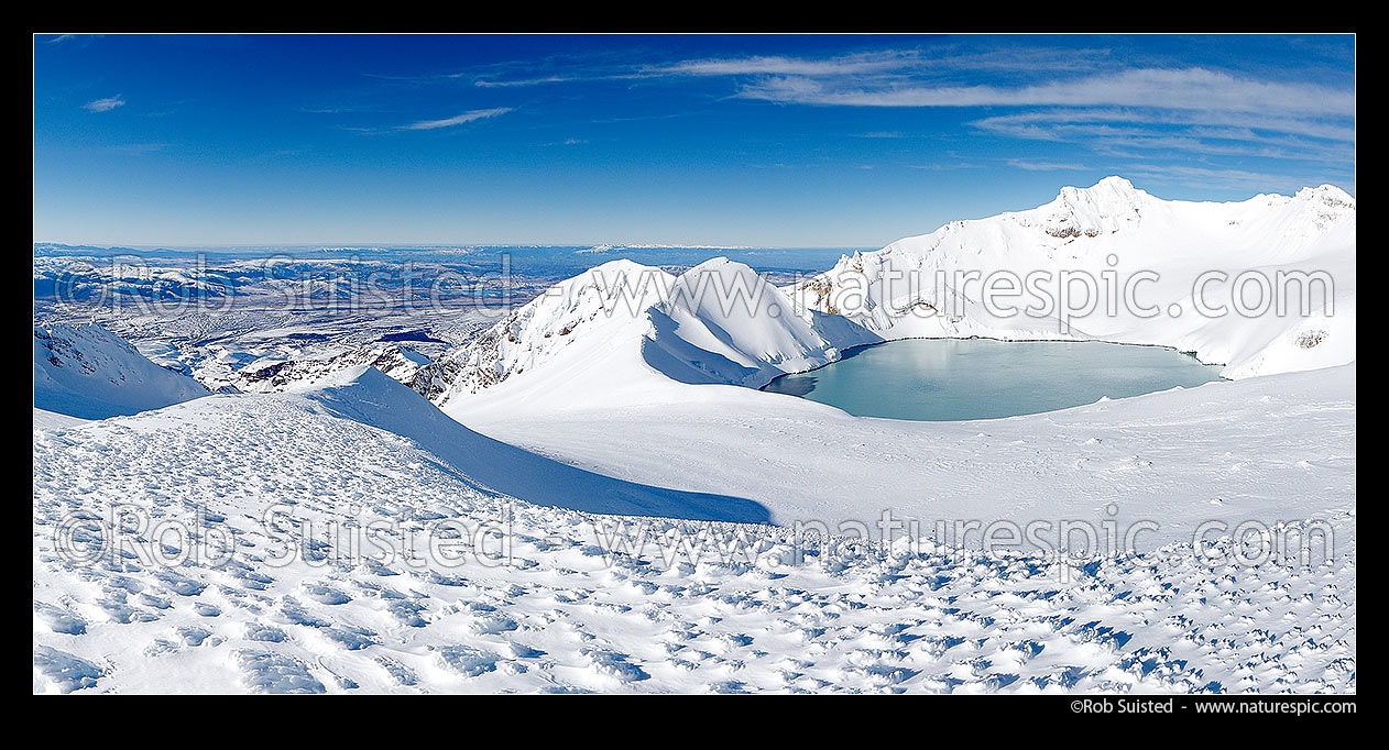 Image of Mount Ruapehu summit plateau (left) and Crater Lake below the summit (Tahurangi 2797m). Wind blown sculptured ice formations and textures. Panorama, Tongariro National Park, Ruapehu District, Manawatu-Wanganui Region, New Zealand (NZ) stock photo image