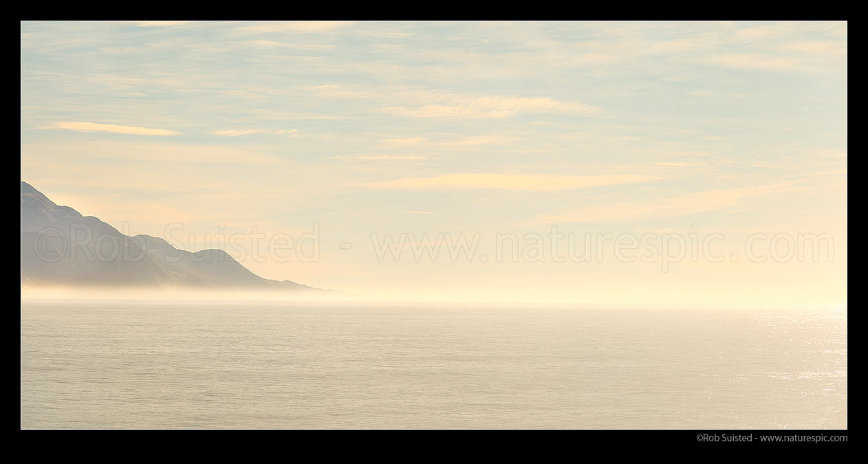 Image of Kaikoura coast north to Clarence River with sea mist in morning light. Panorama, Kaikoura, Kaikoura District, Canterbury Region, New Zealand (NZ) stock photo image