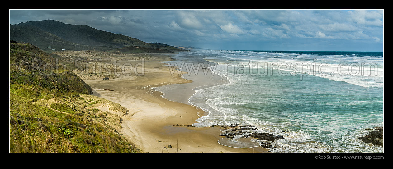 Image of Mitimiti Beach on West Coast of Northland. Panorama over golden sand, as moody weather breaks. Panorama, Mitimiti, Far North District, Northland Region, New Zealand (NZ) stock photo image