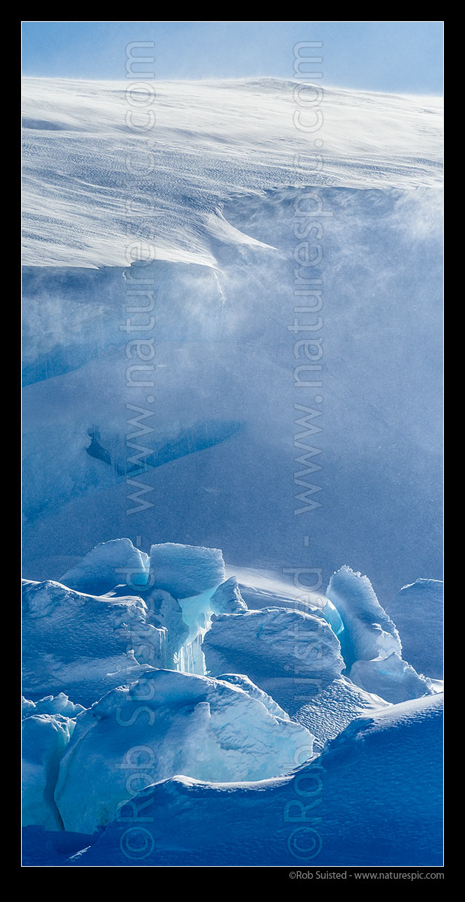 Image of Catabatic blizzard winds blow spindrift, snow and ice particles over the ice sheet and and pressure ridges below. Vertical panorama, Ross Sea, Antarctica Region, Antarctica stock photo image