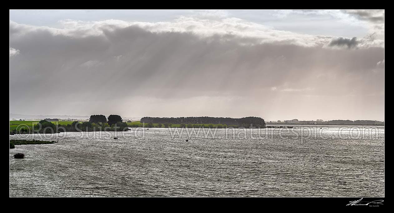 Image of Lake Waikare, on a moody spring day. Duck hunting maimais dotting the lake.  Panorama, Te Kauwhata, Waikato District, Waikato Region, New Zealand (NZ) stock photo image